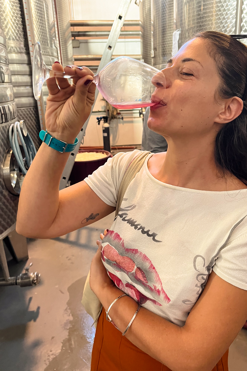 Person tasting wine from a glass