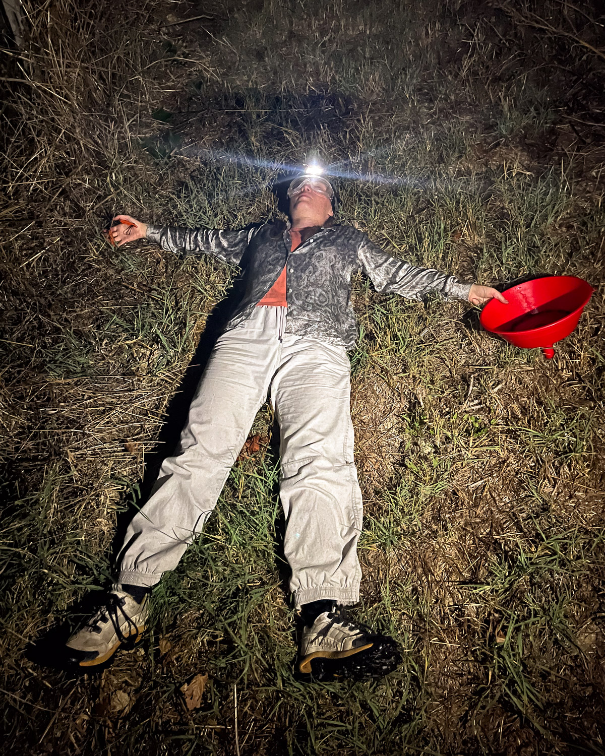 Person lying exhausted on the ground after harvesting