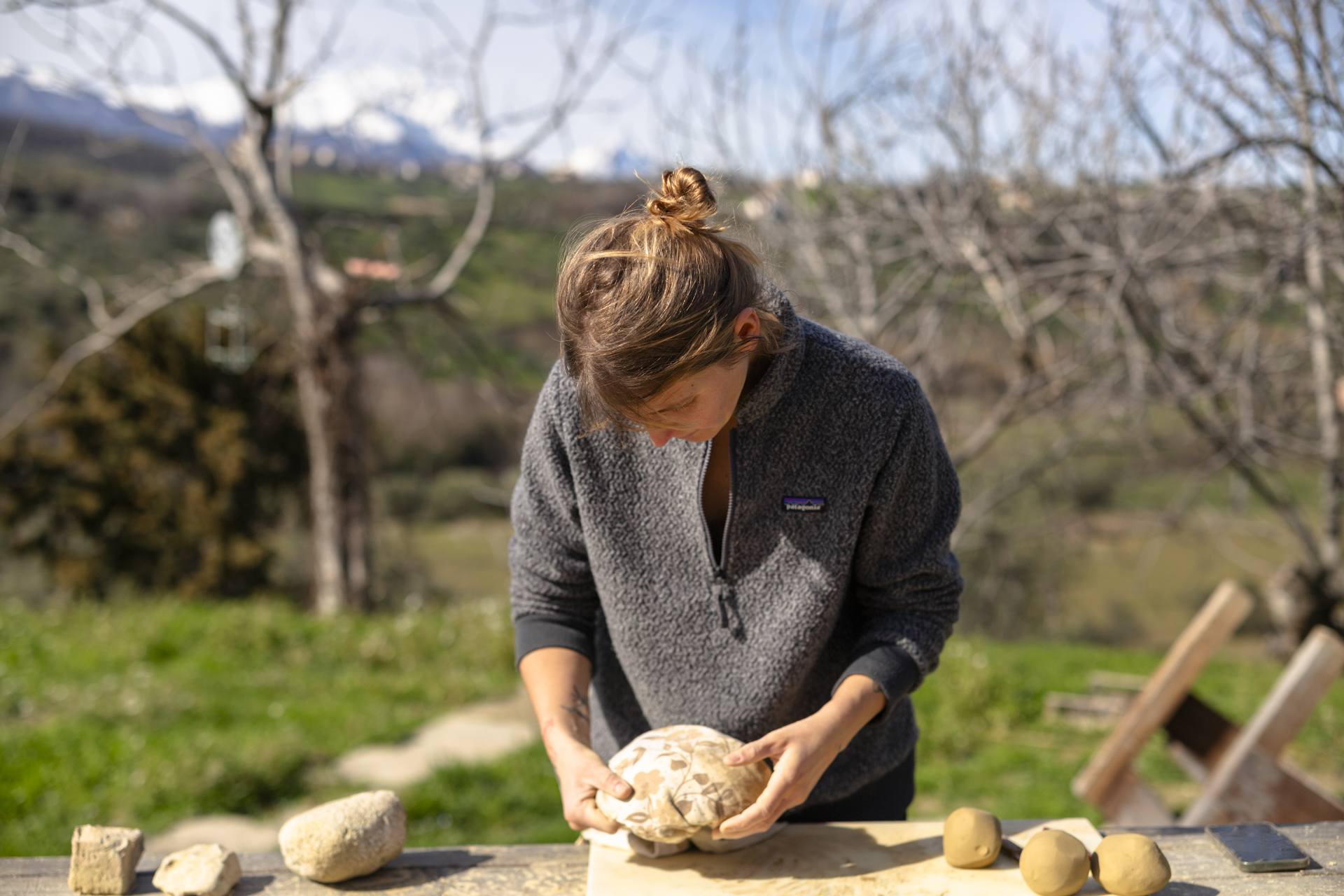 Resident working with clay forms at a table